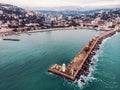 Aerial view of Yalta embankment from drone, old Lighthouse on pier, sea coast landscape and city buildings on mountains, Crimea Royalty Free Stock Photo