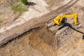 Aerial view of yellow industrial excavator working on construction site Royalty Free Stock Photo