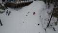 Aerial view of a young boy sledding down a sloping snow-covered hill in Muskoka, Ontario, Canada Royalty Free Stock Photo