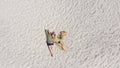 Aerial view of a young couple lying on the white sand. man and woman spend time together and travel through the desert Royalty Free Stock Photo