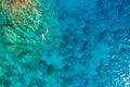 Aerial view of a young couple snorkeling above coral reef reaching deeper parts of the crystal clear water, Rhodes, Greece. Aerial Royalty Free Stock Photo