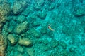 Aerial view of a young couple snorkeling above coral reef reaching deeper parts of the crystal clear water, Rhodes, Greece. Aerial Royalty Free Stock Photo