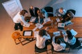 Aerial view of young multiethnic people talking, working with colleagues, co-workers at office, indoors. Work, finance Royalty Free Stock Photo