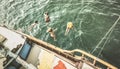 Aerial view of young people jumping from sailing boat at party trip Royalty Free Stock Photo