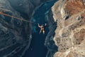 Aerial view of a young woman climbing a cliff. Extreme sport concept, Extreme Bungee jumping on the mountain, top view, no visible Royalty Free Stock Photo