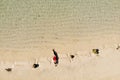 Aerial view of young woman in red bikini lying on beach with white sand, foaming waves of the Indian Ocean. Bali Island, Indonesia Royalty Free Stock Photo