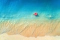 Aerial view of a young woman swimming with the donut swim ring