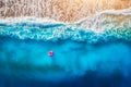 Aerial view of young woman swimming on the pink swim ring