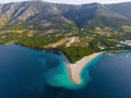 Aerial view of the Zlatni Rat sandy beach, sea and mountains on Brac island, Croatia made with drone Royalty Free Stock Photo