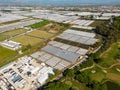 Aerial views of rows of greenhouses taken by drone. Greenhouse roofs background texture