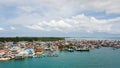 Aerial views of the village near the sea against the background of hills and forests along with many wooden boats lined