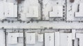 Aerial. Village street in winter. Snow covered rooftops of cottages. Top view