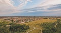 Aerial Village Surrounded with Meadows at sunset