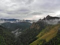 Aerial viw of fog among the mountain peaks. Bad weather and fog in the Siberian nature reserve Stolby.