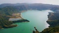 Aerial volcanic island lagoon in morning. Rippling turquoise water wash rocky