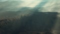 Aerial vulcanic desert landscape with rays of light