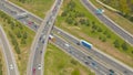 AERIAL White cargo truck drives under highway overpass full of congested traffic