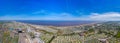 Aerial wide photo of the town centre of Skegness showing the the sandy beach near fairground rides in the East Lindsey district of