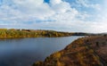 Aerial wide view of lake shore at sunrise in autumn. Meadows, orange grass, trees. Colorful landscape of river sunset. Horodok Royalty Free Stock Photo