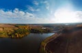 Aerial wide view of lake at sunrise in autumn. Meadows, orange grass. Colorful landscape of river sunset. Horodok Ukraine Royalty Free Stock Photo