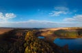 Aerial wide view of lake at sunrise in autumn. Meadows, trees at dawn. Colorful aerial landscape of river coast at sunset in fall Royalty Free Stock Photo