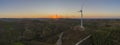 Aerial Wind farm turbines silhouette at sunset. Clean renewable energy power generating windmills. Royalty Free Stock Photo