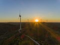 Aerial Wind farm turbines silhouette at sunset. Clean renewable energy power generating windmills. Royalty Free Stock Photo