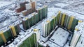 Aerial of winter cityscape with new resiential buildings and the ground covered by snow. Motion. Bird eye view o bright Royalty Free Stock Photo