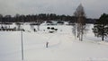 Aerial for winter landscape with pine forest, grey sky and ski track, winter sports game and healthy lifestyle concept