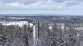 Aerial winter scenery of the Suur Munamagi hill with a watchtower and Estonian flag flying