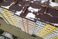 Aerial winter top view of tall apartment building, brick chimneys, tiled roof. Urban infrastructure, view from above