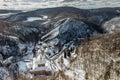 Aerial winter view of Svaty Jan pod Skalou, picturesque little village in Central Bohemia, Czech Republic. Monastery hidden under