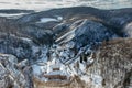 Aerial winter view of Svaty Jan pod Skalou, picturesque little village in Central Bohemia, Czech Republic. Monastery hidden under