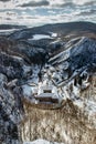 Aerial winter view of Svaty Jan pod Skalou, picturesque little village in Central Bohemia, Czech Republic. Monastery hidden under