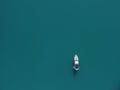 Aerial yacht on calm sea. Luxury cruise trip. View from above of white boat on deep blue water. Aerial top down view of Royalty Free Stock Photo