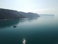 Aerial yacht on calm sea. Luxury cruise trip. View from above of white boat on deep blue water. Aerial top down view of Royalty Free Stock Photo