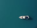Aerial yacht on calm sea. Luxury cruise trip. View from above of white boat on deep blue water. Aerial top down view of Royalty Free Stock Photo