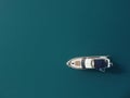 Aerial yacht on calm sea. Luxury cruise trip. View from above of white boat on deep blue water. Aerial top down view of Royalty Free Stock Photo