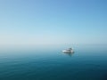 Aerial yacht on calm sea. Luxury cruise trip. View from above of white boat on deep blue water. Aerial view of rich