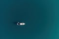 Aerial yacht on calm sea. Luxury cruise trip. View from above of white boat on deep blue water. Aerial view of rich