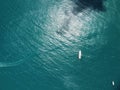 Aerial yacht on calm sea. Luxury cruise trip. View from above of white boat on deep blue water. Aerial view of rich