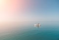 Aerial yacht on calm sea. Luxury cruise trip. View from above of white boat on deep blue water. Aerial view of rich