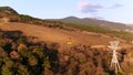 Aerial for yellow funicular with moving on the trees slope background. Shot. Cable railway moving over forested hill