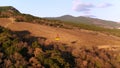 Aerial for yellow funicular with moving on the trees slope background. Shot. Cable railway moving over forested hill