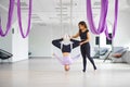 Aerial yoga, woman and female instructor