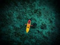 Aeriel panorama of young female person woman girl in red yellow kayak floating on clear blue ocean water Mallorca Spain Royalty Free Stock Photo