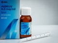 AERIUS 0.5 mg/ml syrup in amber glass bottle and measuring syringe. Desloratadine 60 ml is antihistamine drug.