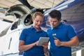 Aero Engineer And Apprentice Working On Helicopter In Hangar Loo Royalty Free Stock Photo