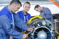 aero engineer and apprentice working on helicopter in hangar Royalty Free Stock Photo