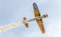 Aerobatic airplane pilot Jurgis Kairys training in the sky of the city. Colored airplane with trace smoke, airbandits, aeroshow